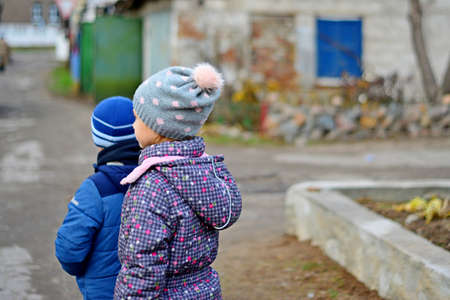 Children are on the street in the city in winterの写真素材