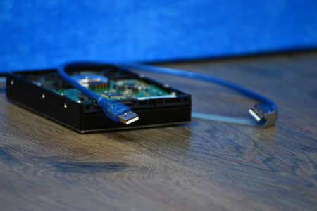 The USB cable and hard disk with the video card are on the table in disassembled form