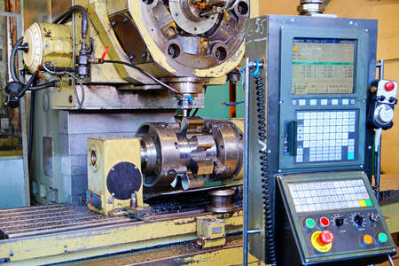 Manufacturing of gears on the CNC milling machine close-up.