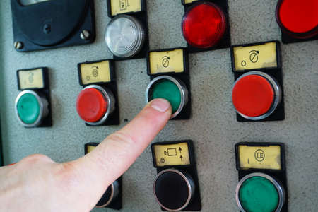 The operator switches the control mechanisms on the machine to the control panel.の写真素材