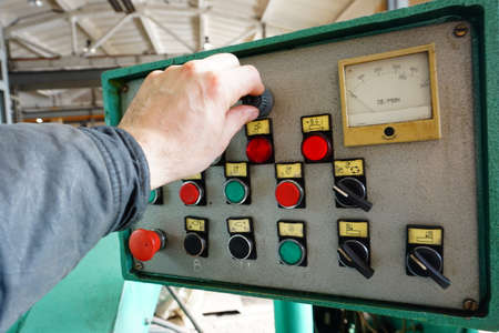 The operator switches the control mechanisms on the machine to the control panel.の写真素材