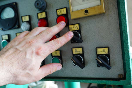 The operator switches the control mechanisms on the machine to the control panel.の写真素材