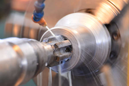 Thread tapping, on the machine with water cooling. Modern manufacturing process.の写真素材