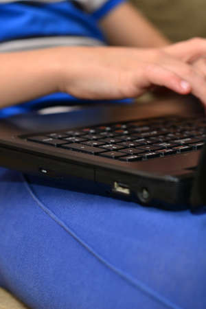 Smart Young Boy Works on a Laptop For His New Project in His Computer Science Class.の写真素材