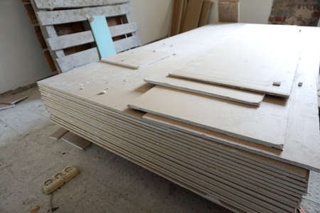 A pack of plasterboard is on the construction site in a room prepared for repair and decoration of a dwellingの写真素材