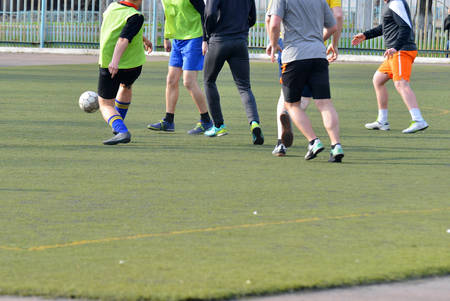 Football game of people on a responsible match on the green fieldの写真素材