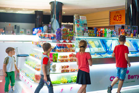 Mariupol, Ukraine, May 26, 2018: Four children near a counter with ice cream in a shopping center.のeditorial素材