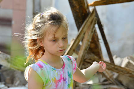 lLittle orphans were left without housing and stand near the ruins of the building as a result of a...