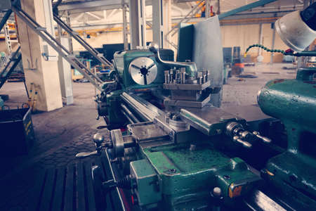 Lathe, metal processing by cutting on industrial equipment. Tinted image.