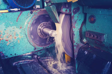 Processing of metal on a grinding machine with sparks, at an industrial plant.の写真素材