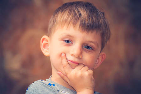 A boy strongly emotional shows a different face to the cameraの写真素材