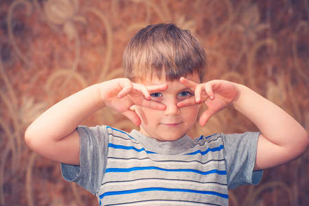 A boy strongly emotional shows a different face to the camera
