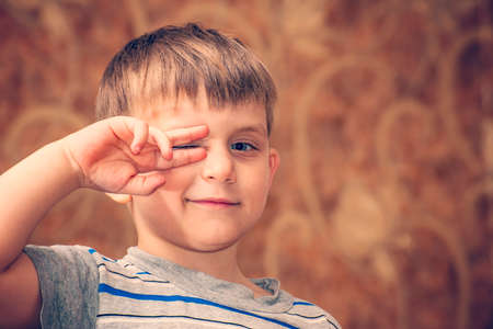 A boy strongly emotional shows a different face to the cameraの写真素材