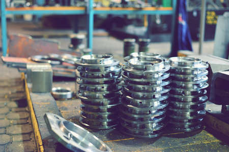 Round iron parts after turning and milling processing are located in the factory