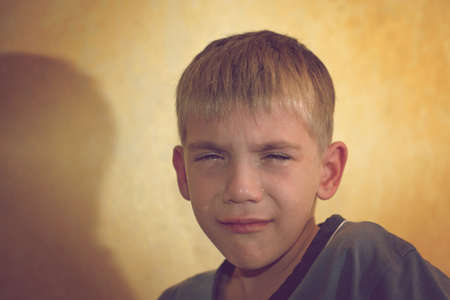 Angry, sad and unhappy baby child. shouting and crying. problem child with head in hands. concept for bullying, depression stresの写真素材