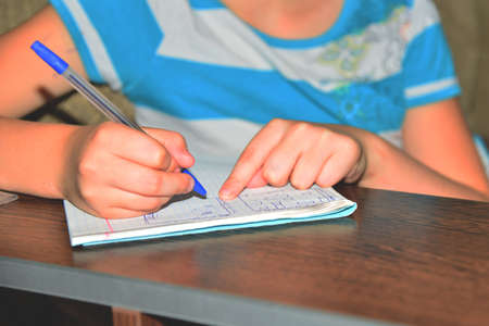 Children draw ships on a sheet in a box, play a sea battle
