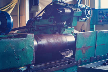 A large round piece is mounted on the machine and is ready for machining, grinding a large shaft on...