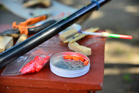 Fishing gear and gears are on the table, hooks, floats, loads.