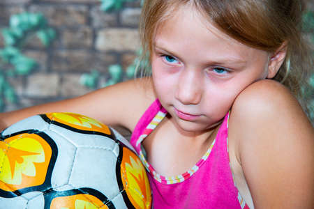 The girl is holding a soccer ball.の写真素材