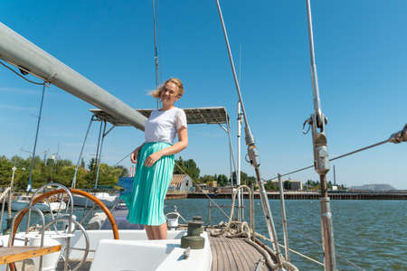 Beautiful and joyful girls, smiling friends, on the deck of a yacht