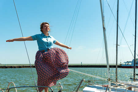 Beautiful and joyful girls, smiling friends, on the deck of a yacht
