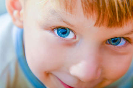 Closeup portrait of a boy with blue eyesの写真素材