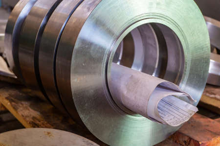 Round parts with drawings after turning are on a wooden rack in the workshop