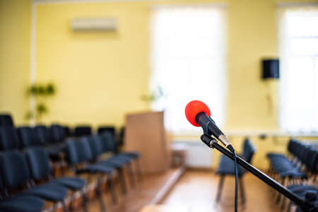 Red microphone in an empty room, the concept of emptiness and despair in human life, emptiness and the abyss in the soul of a lonely creatureの写真素材