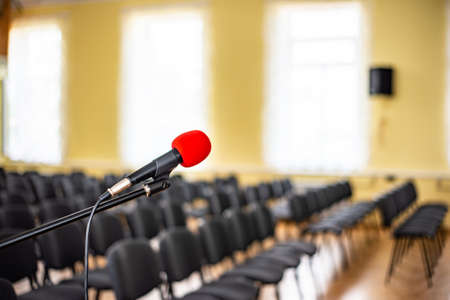 Red microphone in an empty room, the concept of emptiness and despair in human life, emptiness and...