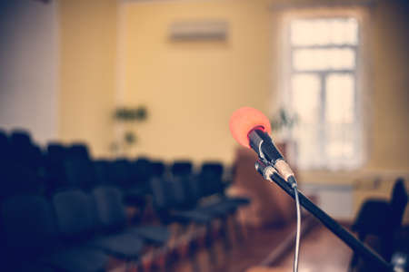 Red microphone in an empty room, the concept of emptiness and despair in human life, emptiness and the abyss in the soul of a lonely creatureの写真素材