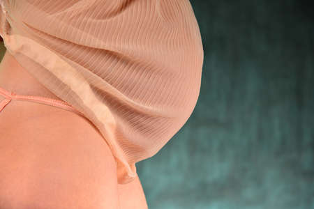 Beautiful sexy pregnant girl is standing sideways, belly closeupの写真素材