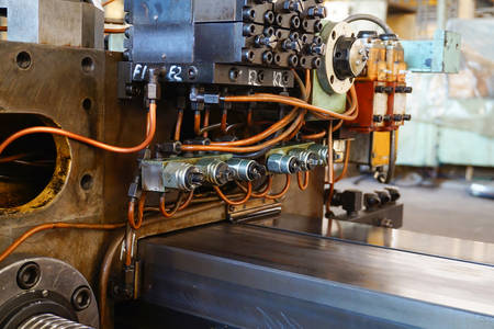 The hydraulic system on the machine, copper oil tubes connected to the equipment in production. Bed...