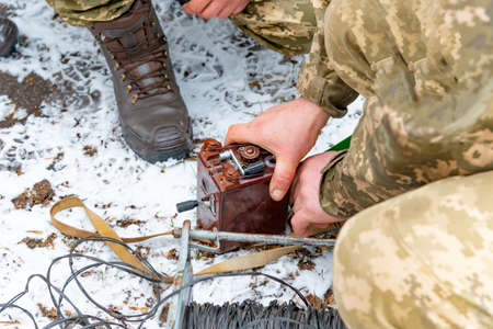Military soldiers explode a bomb with a detonator.の写真素材