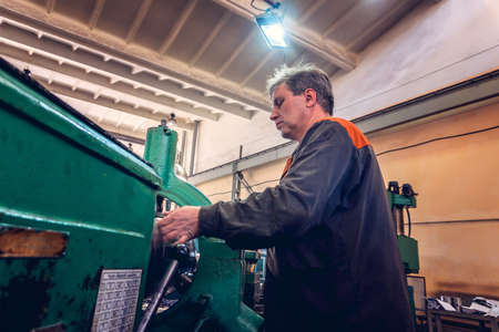 Turner for the machine, the machine operator controls the technological process of cutting and metal processing.の写真素材