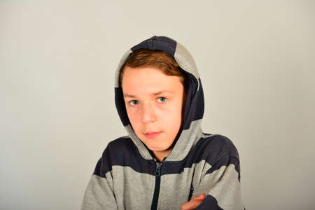 Portrait of a guy in the hood on a gray backgroundの写真素材