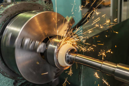 Internal processing of the hole with an abrasive stone on a grinding machine, sparks fly in...