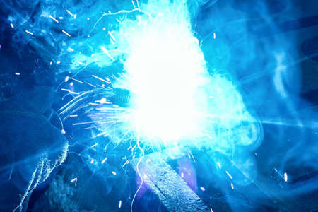 The worker performs welding work at the plant, welding, smoke and fireの写真素材