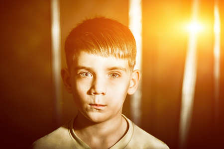 Portrait of a boy with flare, toned photo
