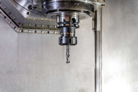 Drill in the collet on the CNC machine, close-up engineering production.の写真素材