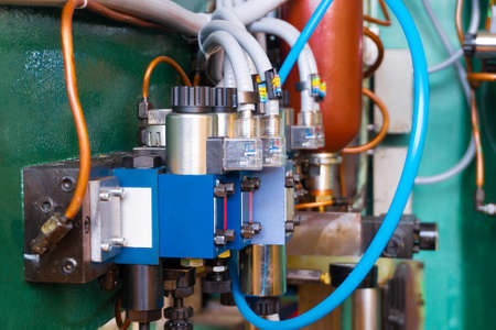 Hydraulic system of the machine, oil under pressure in hydraulic pipes, repair of industrial...