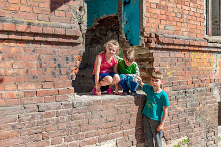 Three children in a destroyed house are hiding from military conflicts, refugee children have suffered from the destruction of terrorist acts of violence. Submission photo.の写真素材