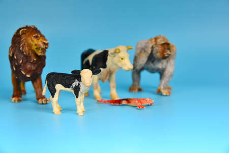 Toy animals made of plastic on a blue background, baby little animals.の写真素材
