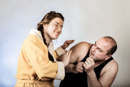 Husband strangles and beats his wife, family conflicts in the form of staged. The concept of social problems within the family.の写真素材