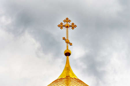 Orthodox Church, golden domes with crosses close-up against a blue cloudy sky, HDR photo.の写真素材