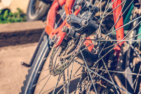 Bicycle disc brakes close up. Red bike parked.