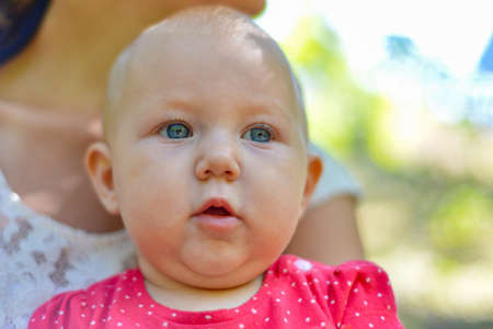 Portrait of a mother with a child in nature resting from the bustle of the city.の写真素材