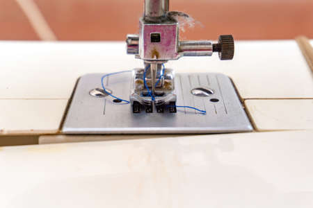 Sewing machine, closeup needle and presser foot with holder.