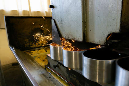 Flat grinding of metal on a machine with sparks, technological grinding of parts alignment.の写真素材