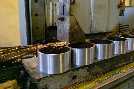 Flat grinding of metal on a machine with sparks, technological grinding of parts alignment.の写真素材