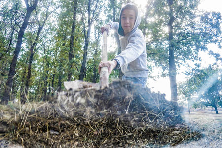 A man buries the ground with a shovel and throws it from above, a view from inside from below.の写真素材
